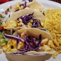 Shrimp Tacos · 3 corn tortillas stuffed with cabbage, sauteed shrimp. Served with rice, charro beans, guaca...
