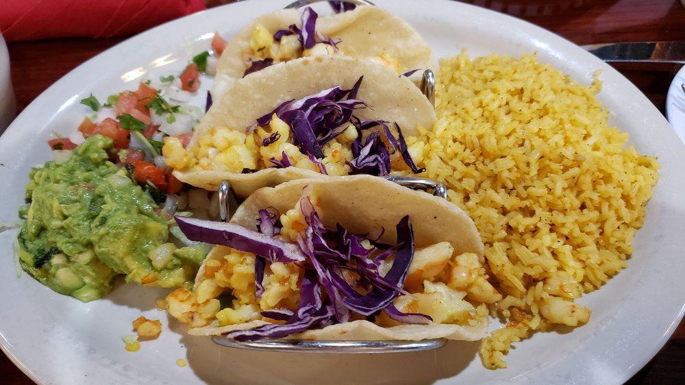 Shrimp Tacos · 3 corn tortillas stuffed with cabbage, sauteed shrimp. Served with rice, charro beans, guacamole, and pico de gallo.