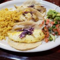 Fish Tacos · 3 corn tortillas stuffed with cabbage and grilled tilapia. Served with rice, charro beans, g...