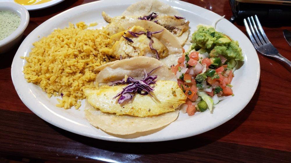 Fish Tacos · 3 corn tortillas stuffed with cabbage and grilled tilapia. Served with rice, charro beans, guacamole, and pico de gallo.