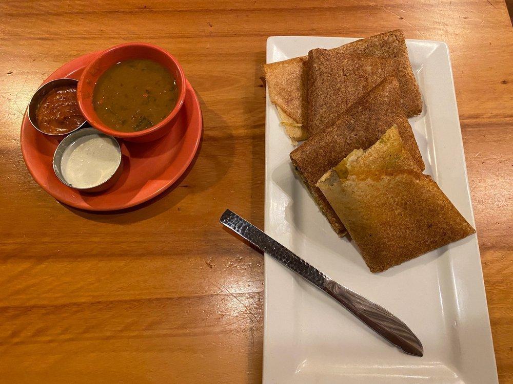 Masala Dosa · (GF) (VEG) Savory rice and lentil crepes service with fresh coconut & tomato chutneys and sambar (lentil soup) Traditional filing of spiced mashed potatoes