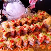 Golden Spider Roll · Inside: soft shell crab and avocado. Outside: spicy yellowtail, crunch, tobiko and scallion ...