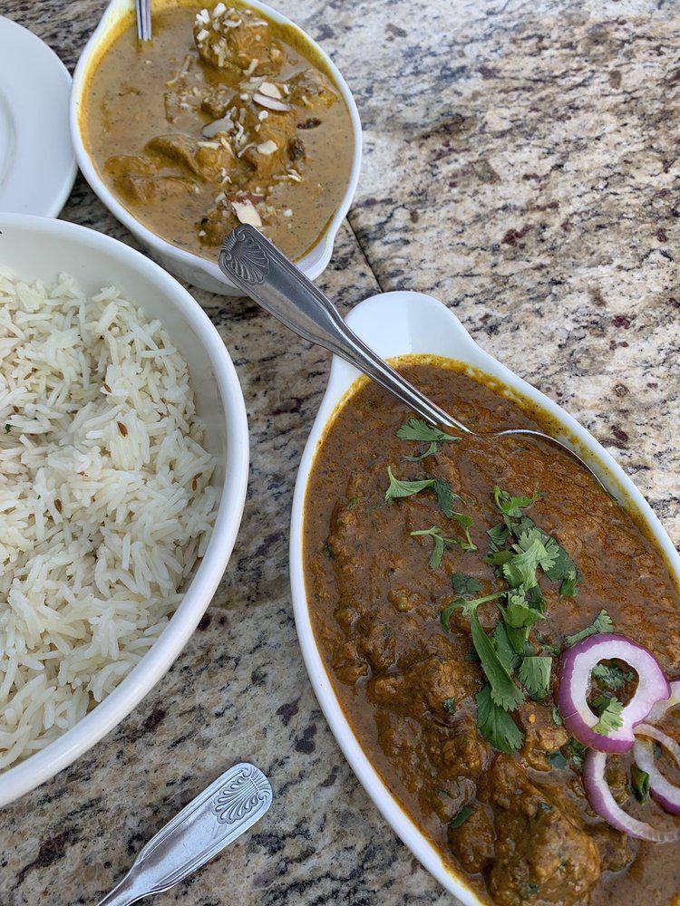 Lamb Rogan Josh · Boneless lamb cooked with a curry sauce of onions garlic, ginger, tomatoes and almonds. Curry is a blend of onions, tomatoes, garlic, gingers, spices and herbs. With imported basmati rice.