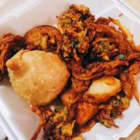 Onion Bhaji · Mildly spiced sliced onion dipped in homemade chickpea flour batter deep-fried light and cri...