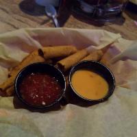 Beef Taquitos · Corn tortillas filled with shredded beef and lightly fried. Served with a side of queso and ...