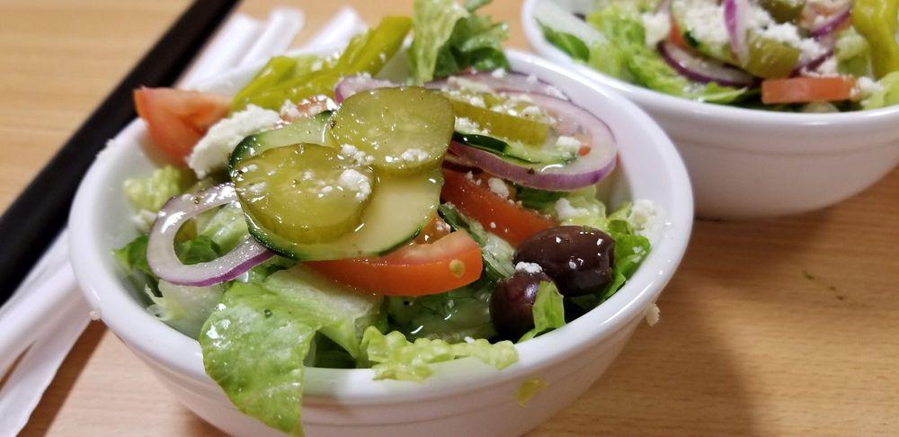 Greek Salad · A blend of fresh romaine lettuce, tomatoes, onions, cucumbers, and Kalamata olives topped with olives oil and feta cheese.