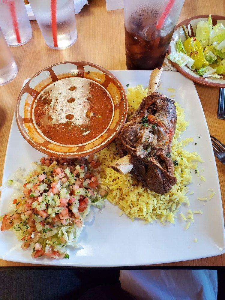 Lamb Shank · Tender lamb shank blended with our special spices served with rice and Arabic salad.