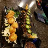 Flaming Mignon Roll · 2 shrimp tempura, spicy crab, topped with seared filet mignon and jalapenos in spicy mayo an...