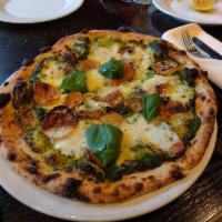 Basil Pizza · Pesto sauce, homemade fresh mozzarella cheese, oven-baked rosemary potatoes, pine nuts, extr...