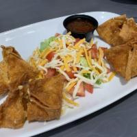 Crab Wontons · House-made wontons stuffed with fresh crab meat and melted cheeses, fried golden brown and s...