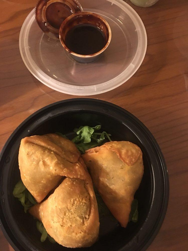 Samosa · Spiced potatoes and peas, crispy fried in a thin pastry pyramid.