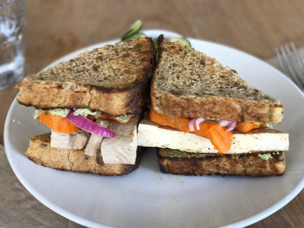 Nourish Banh Mi Sandwich · Marinated tofu (aminos, ACV, garlic, tamari, paprika), sweet potatoes, pickles, cilantro, jalapeno cashew mayo, sea salt.