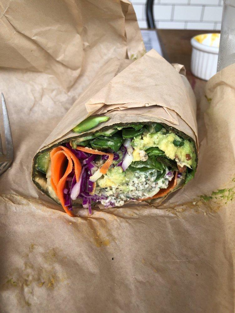 Veggie Wrap · Hummus, avocado, carrots, sprouts, red peppers, romaine lettuce, cabbage, cucumber, oil-free creamy dill hemp dressing. Served in a raw spinach wrap (gluten-free).