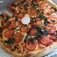 Margherita Pizza · Fresh tomatoes and basil cooked with pizza or added after.