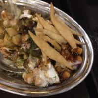 Papri Chaat · Chickpeas, potatoes and onions topped with yogurt, tamarind sauce, and flour crisps.