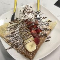 Paris Crepe · Nutella, hand sliced bananas, and strawberries, topped with hazelnut and whip-creme.