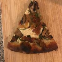 Wild Mushroom and Arugula Pizza · Bechamel, arugula, mozzarella, herb and garlic mushrooms, 
caramelized onion and fontina.