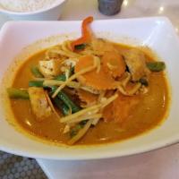 Red Curry · Thai red curry paste with bamboo shoots and basil in coconut milk. Spicy.