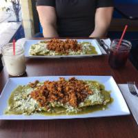 Chilaquiles · Fried tlayuda pieces topped with our house spicy or mild salsa, cheese (queso fresco) and re...