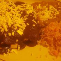 Mole Poblano · Chicken breast in brown mole sauce, rice, beans and corn tortilla.