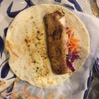 California Fish Tacos · Topped with red cabbage and a creamy chipotle sauce. Three tacos in corn tortilla served wit...