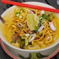 Khao Sauy · Chiang mai noodles. Served with soft egg noodles, onions, cilantro and Asian shallots in nor...