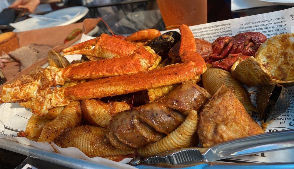 Boiling Pot · Snow crab, crawfish, shrimp, clam, mussel, calamari, sausage, shell pasta, corn, and potato with the option to add more.