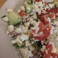 Greek Salad · Tomatoes and cucumber mixed with red onion, olives, feta cheese, pepperoncini and parsley. D...