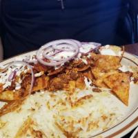 Chilaquiles · Chorizo, red sauce, corn tortilla chips, topped with 2 scrambled eggs, red onions, queso fre...