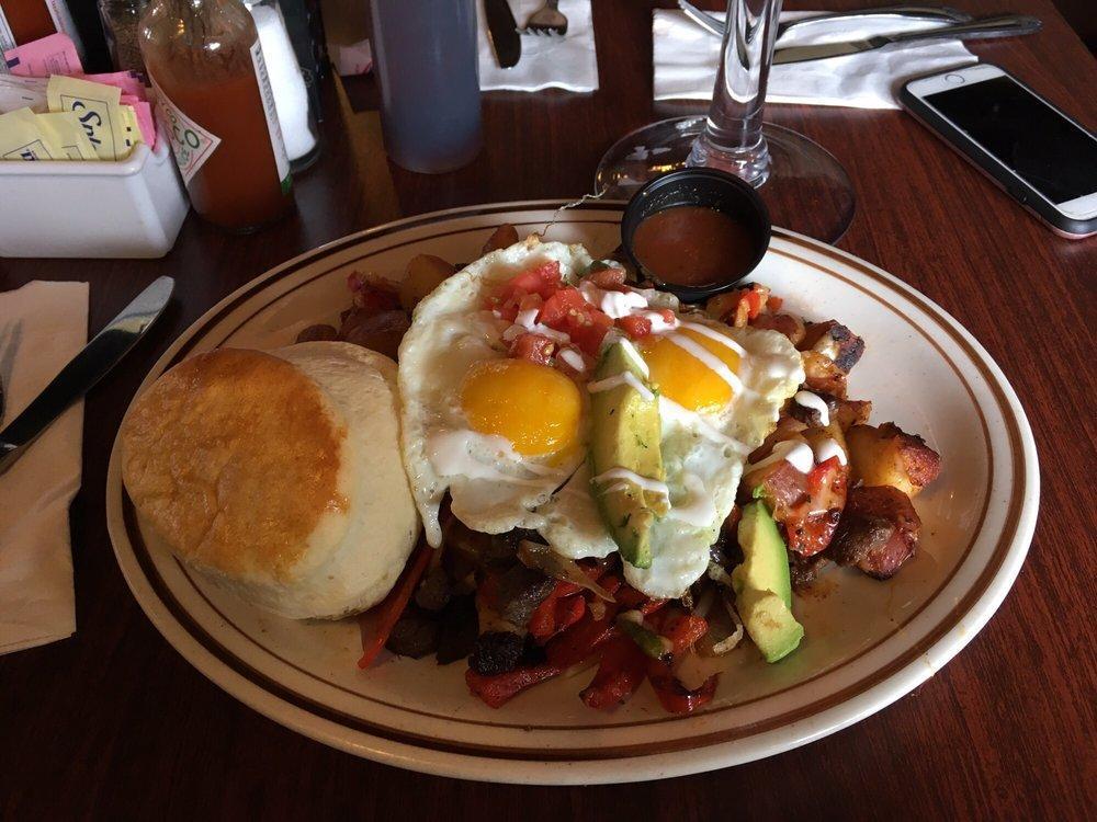 Mexican Skillet · Homemade country potatoes, skirt steak, mushroom, red peppers, onions topped with jack cheese, avocado, sour cream, pico de gallo and salsa. Topped with 2 eggs any style and served with a home made biscuit.