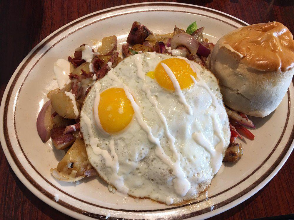 Corned Beef Skillet · Homemade country potatoes, slow corned beef brisket, red onions, jack cheese, parsley and creamy horseradish sauce. Topped with 2 eggs any style and served with a home made biscuit.