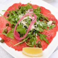 Carpaccio · Thinly-sliced peppercorn-crusted beef with arugula, capers, pickled red onions, lemon ＆ Parm...
