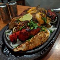 Tandoori Mix Grill · Combination of seekh kebab, chicken tikka kebab, barah kebab, tandoori chicken and and a pra...