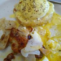 Eggs Benedict · Open face English muffin with ham, 2 poached eggs, hollandaise sauce and a side of home fries.