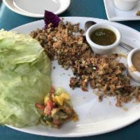 Chicken Lettuce Wraps · Minced chicken, water chestnuts, roasted cashews, toasted coconut flakes, red onion and cila...