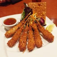 Coconut Shrimp Skewers · Hand-breaded coconut shrimp served with orange-pineapple sauce, sweet and spicy dipping sauce.