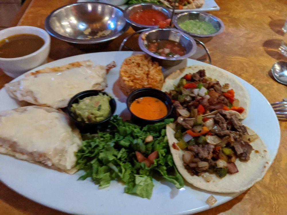 Alambre Beef Tacos No. 48 · Diced sirloin of beef sauteed with bacon, onions, and bell peppers, served on 2 corn tortillas with lettuce, refried beans, and rice.