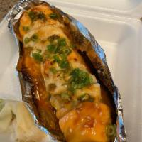 Lion King Roll · Inside: shrimp tempura, avocado and imitation crab. Outside: Salmon, scallop, and vegetable ...