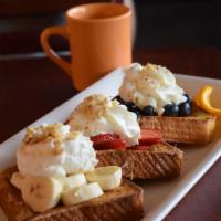 French Riviera · 3 pieces of French toast overstuffed to the max with strawberries, bananas, blueberries, top...