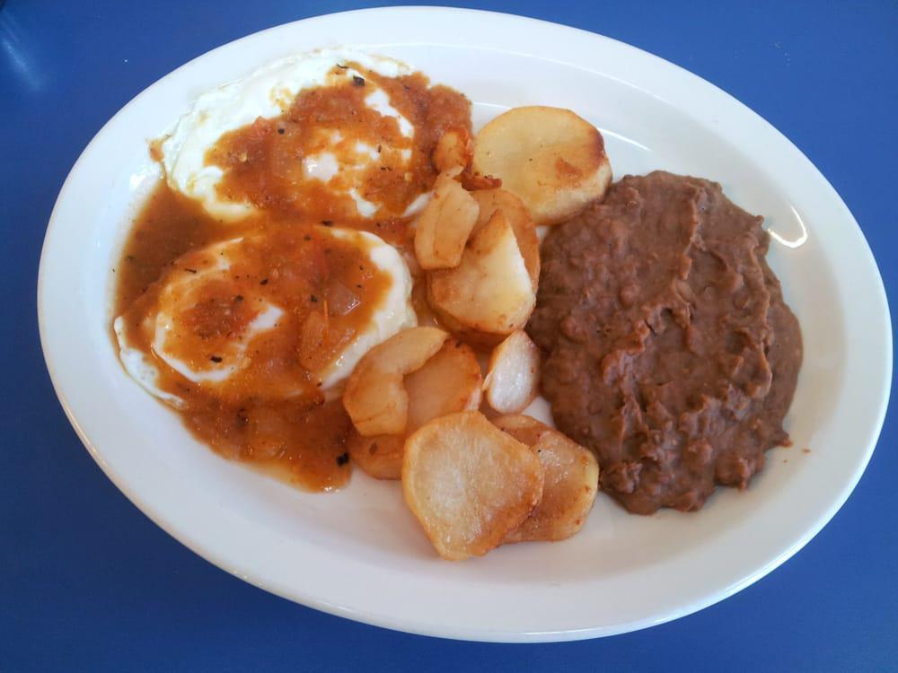 Huevos Rancheros Plate · Two over easy eggs with salsa, homestyle potatoes and beans.