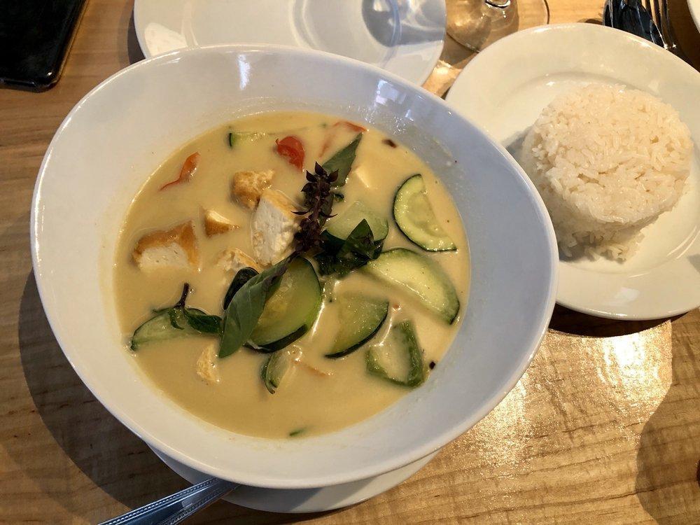 Green Curry · Traditional Thai green curry with coconut milk, eggplants, bamboo shoots, green & red bell peppers, zucchini, peas, lime leaf & Thai basil. Spicy.