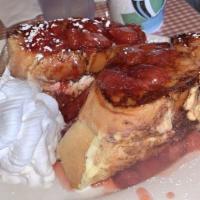 Strawberry Stuffed French Toast · Fresh Strawberries mixed with cream cheese, topped with warm strawberry puree, powder sugar ...