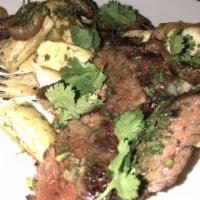 Churrasco · Grilled skirt steak, fried yucca, vidalia onions and chimichurri. Gluten free.