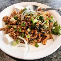 Larb · Minced chicken or beef mixed with roasted rice powder, mixed greens, onions and cilantro. Se...