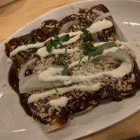 Enchiladas Mole · Slow cooked duck, pickled onions, queso fresco, crema, house made 29 ingredient 