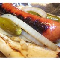 Polish Sausage · Served on a sesame seed bun. Includes grilled onions and sport peppers.