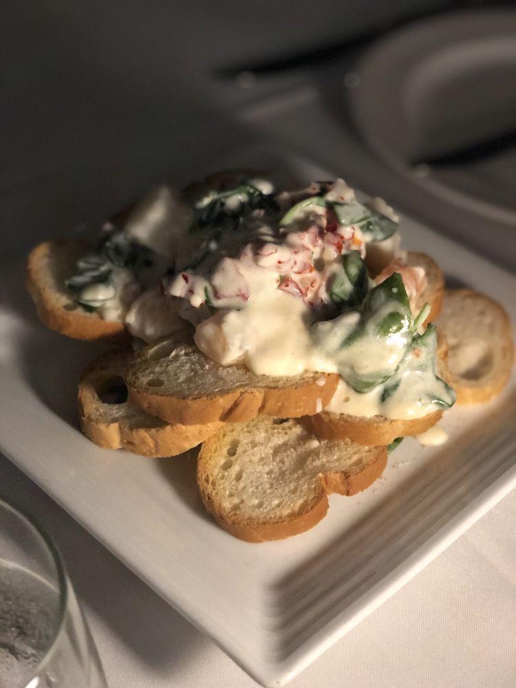 Seafood Bruschetta · Mascarpone cream bruschetta served with sautéed shrimp, scallops, sundried tomato and spinach.