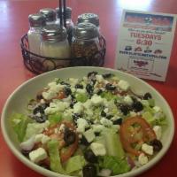 Greek Salad · Romaine lettuce, tomatoes, onions, cucumbers, black olives, feta cheese, and house dressing.