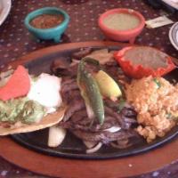 Beef Fajita Quesadilla · Handmade flour tortillas filled with melted cheese, served with guacamole, sour cream and pi...