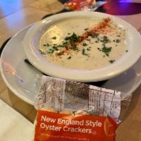 Clam Chowder · House made creamy New England clam chowder with chopped clams, potatoes herbs and spices.